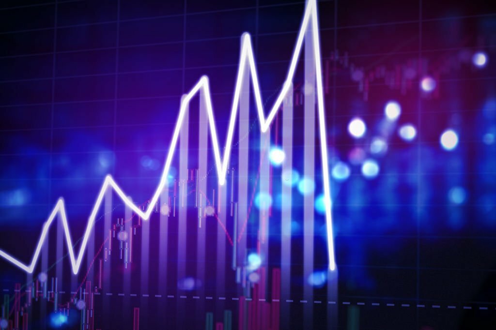 Image of finance chart showing a sharply declining and crashing price with blurred sparkling light background